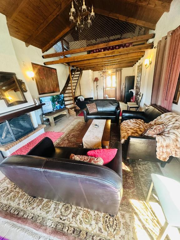 a living room with a leather couch and a table at CHALET MARIA livadi in Arachova