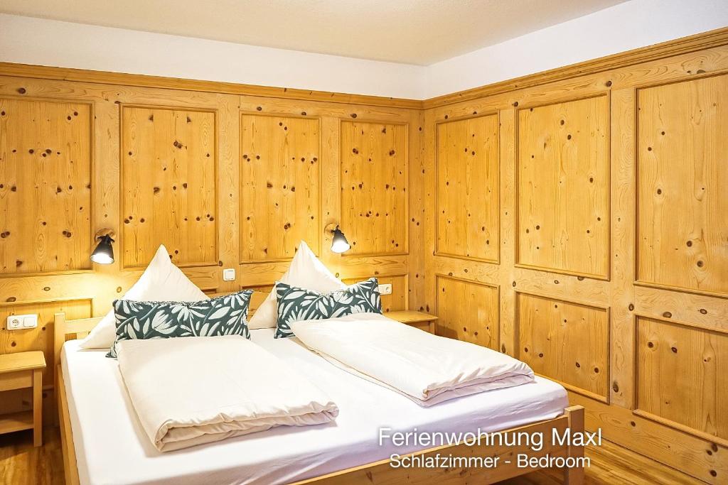 a bedroom with wood paneled walls and a bed at Ferienwohnung Maxl in Schwangau