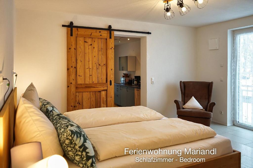 a bedroom with a bed and a wooden door at Ferienwohnung Mariandl in Schwangau