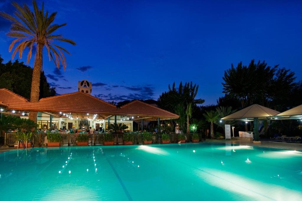 a large swimming pool at night at Marvıda Hotel Akman Park in Kemer