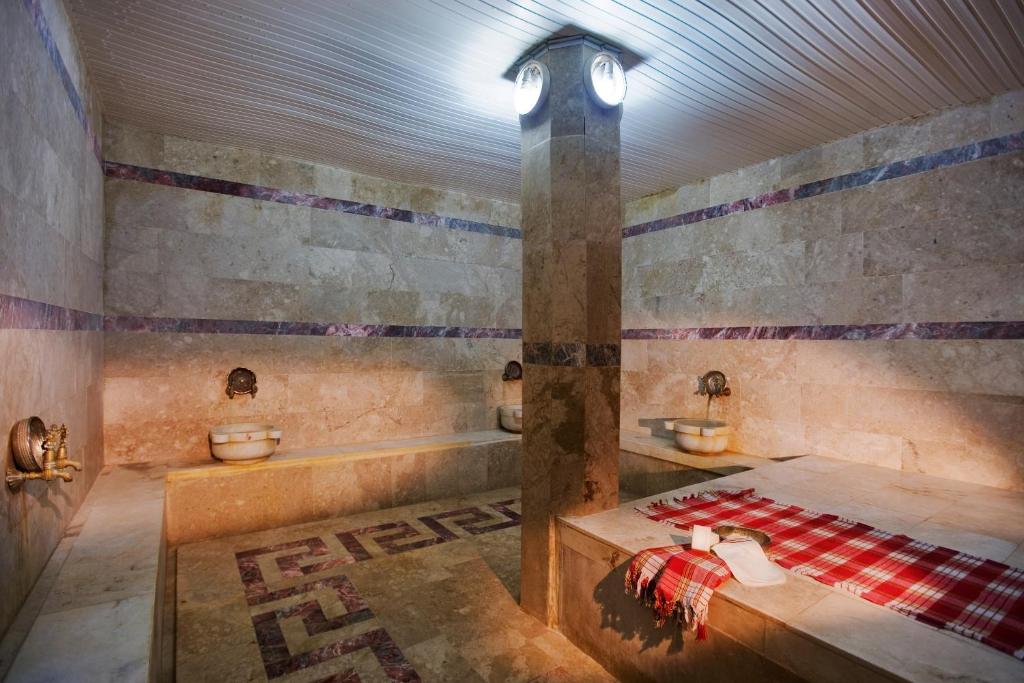 a bathroom with two sinks and a bath tub at Marvıda Hotel Akman Park in Kemer