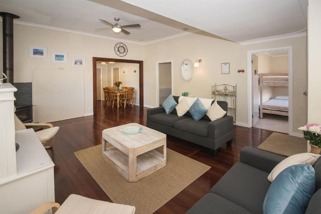 a living room with a couch and a table at Sea La Vie in Busselton