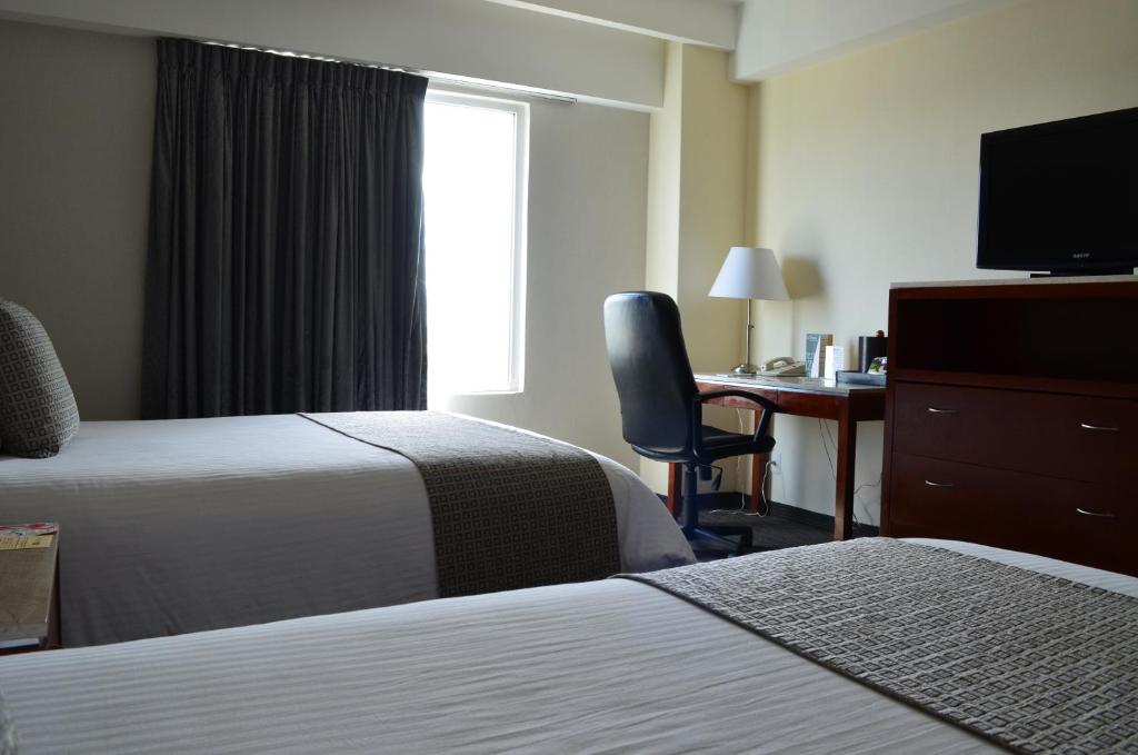 Postel nebo postele na pokoji v ubytování Casa Inn Business Hotel Celaya