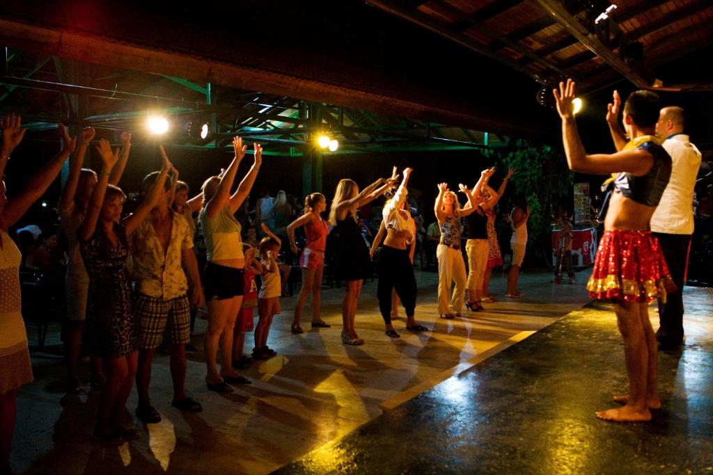 a group of people dancing on a stage at Marvıda Hotel Akman Park in Kemer