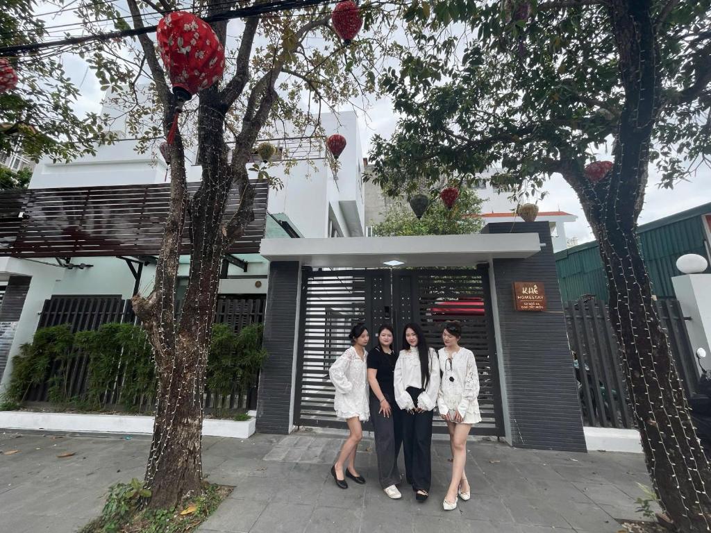 a group of three women standing in front of a building at Khế Homestay Phố Cổ Ninh Bình in Ninh Binh