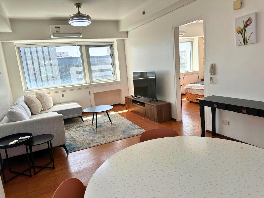 a living room with a couch and a table at Grand Cenia Residences in Cebu City