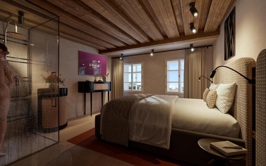 a bedroom with a bed and a glass wall at La Maison in Salzburg