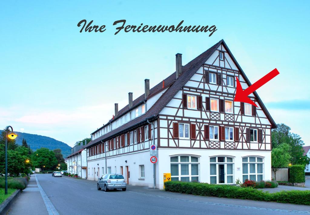 a white building with a red x in front of it at Ferienwohnungen Eibner in Dettingen an der Erms