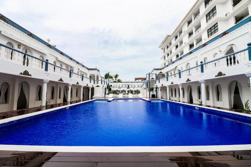 a swimming pool in the courtyard of a building at Boracay Summer Palace Hotel in Boracay