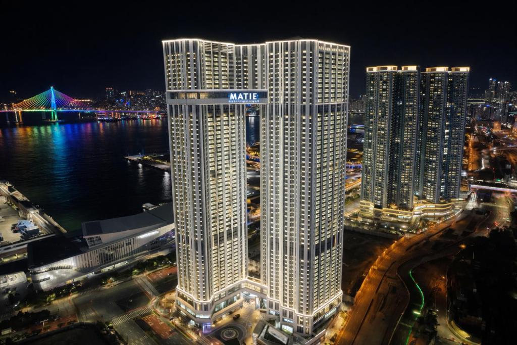 a large building with a nike sign on top of it at Matie Busan Harbor City in Busan