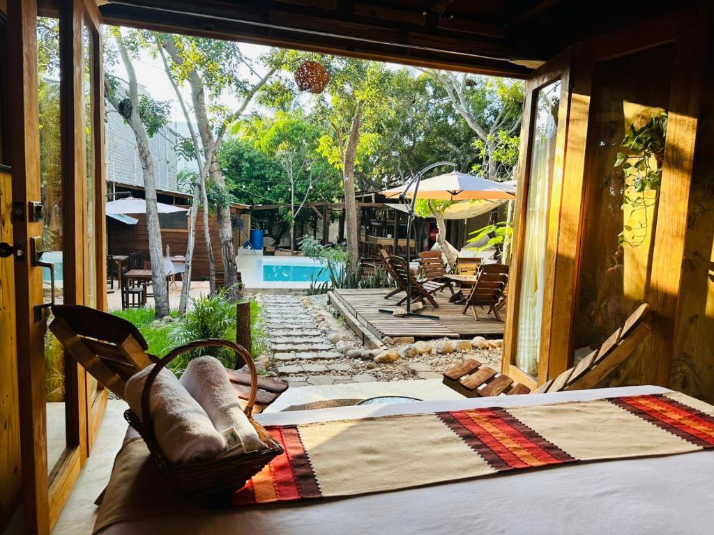 a room with a bed and a view of a patio at Straw hat suites La punta in Santa María Colotepec