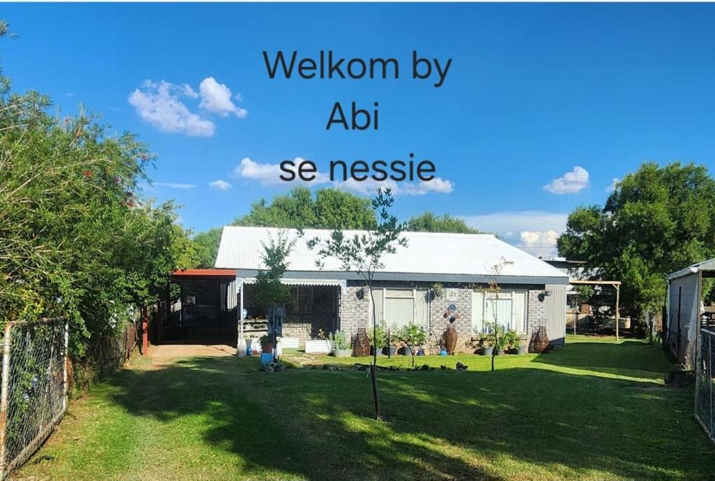 a house with the words wisdom by abdi see message at Abi se Nessie in Orania