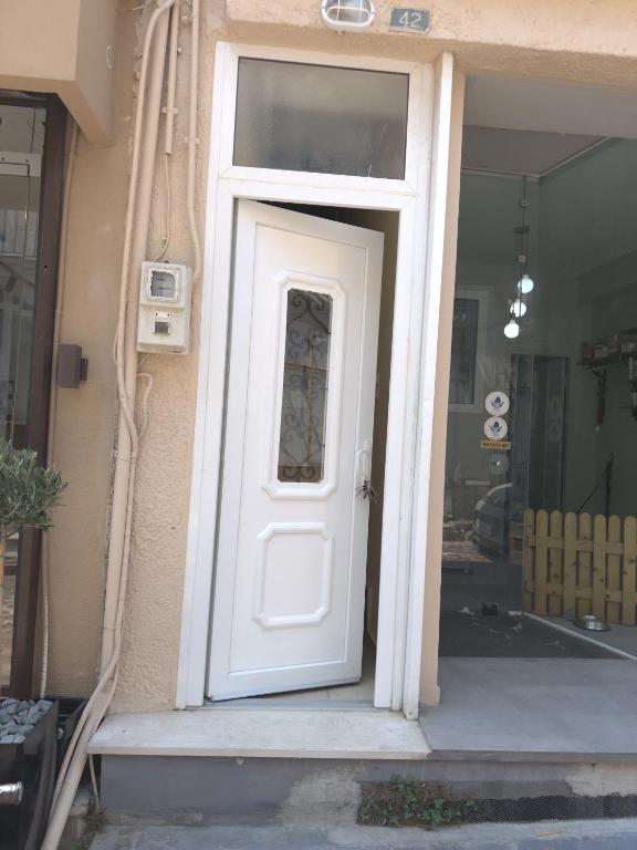 a white door on the side of a building at Volakis apartments in Chios