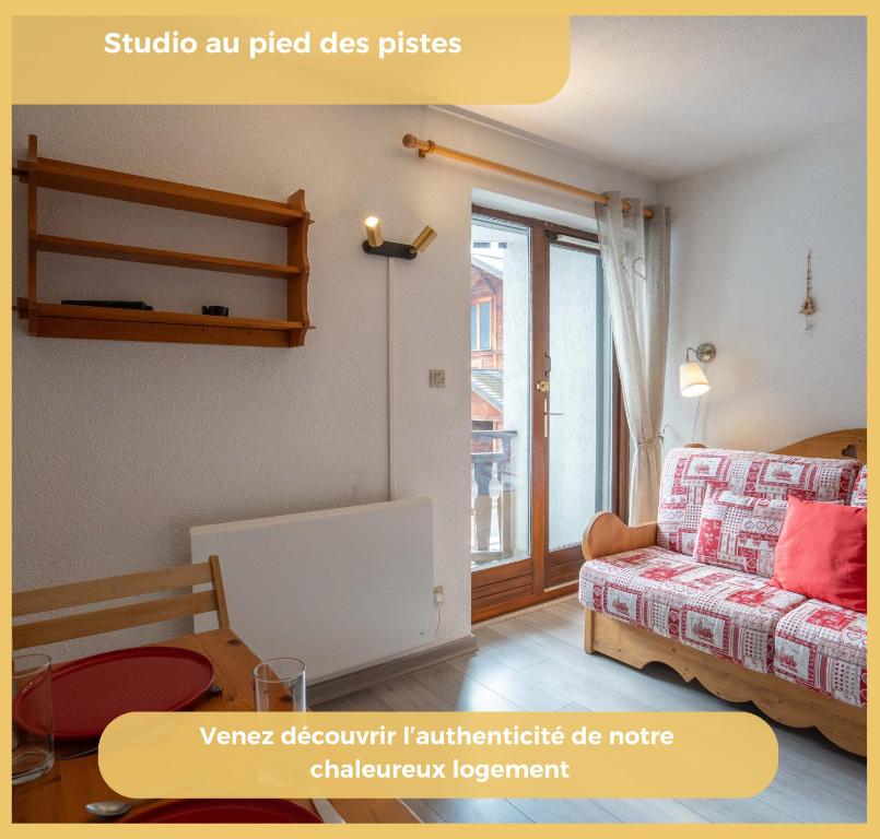 a living room with a couch and a window at Chez Candide I Studio I Montriond in Montriond