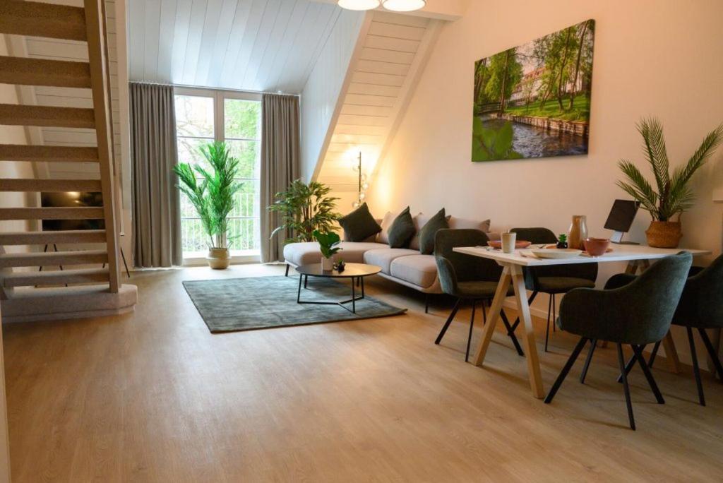a living room with a couch and a table at InselMühle in Munich