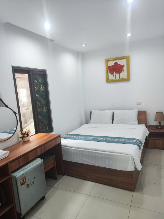 a bedroom with a large bed in a room at okaeri hotel in Hanoi