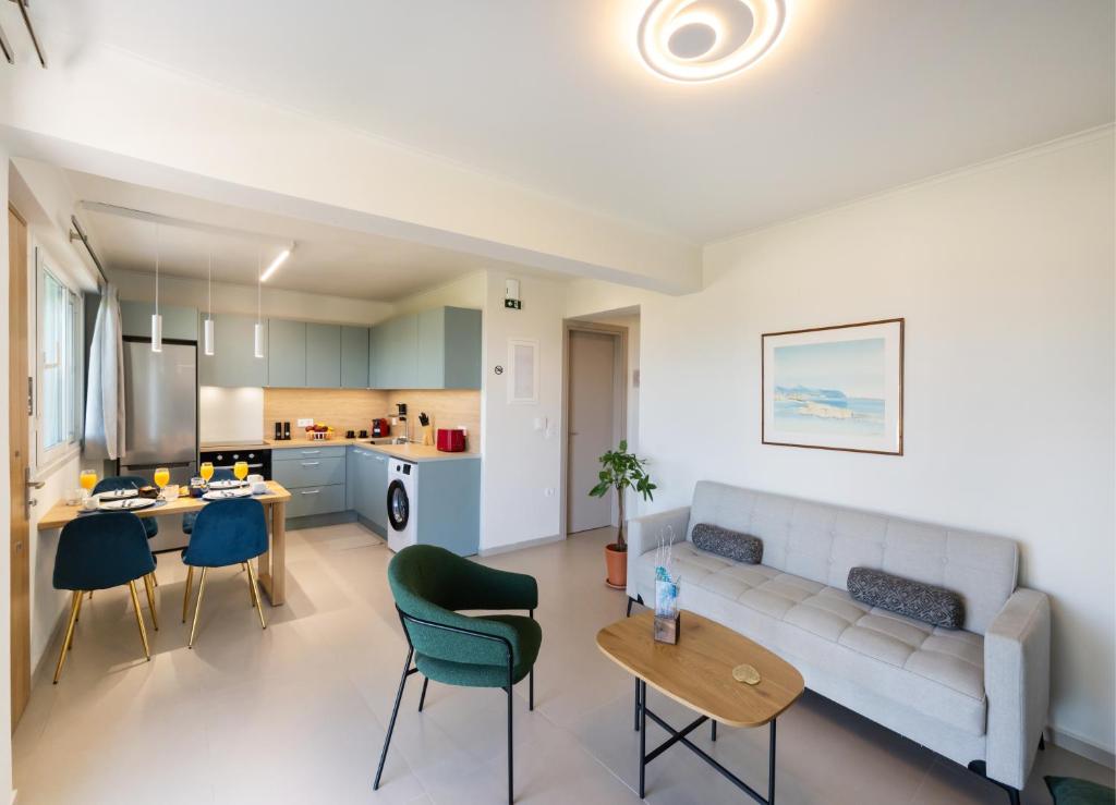 a living room and kitchen with a couch and a table at Asmira Apartments in Lygia