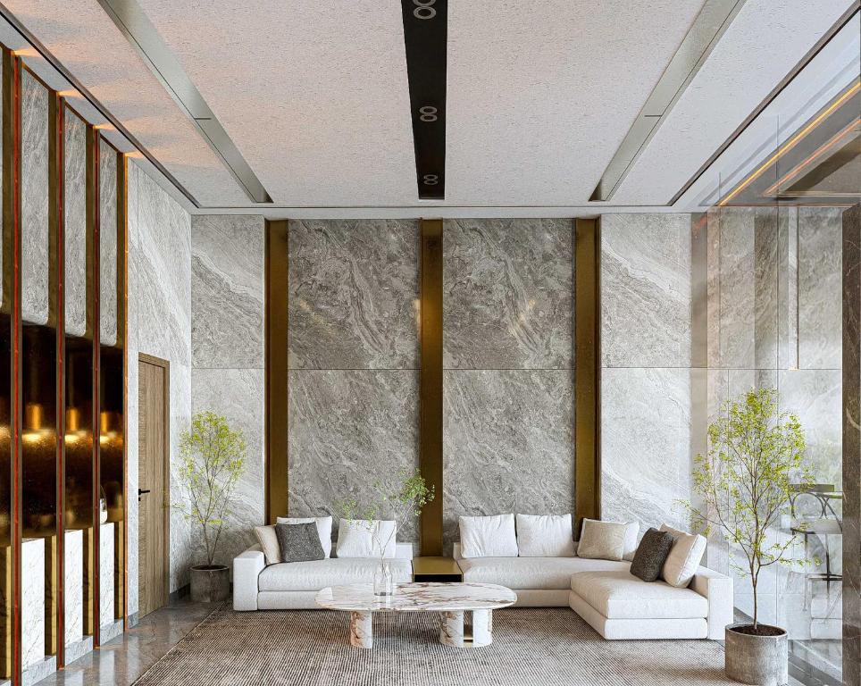 A bright lounge offers deep white sofas around a marble coffee table.