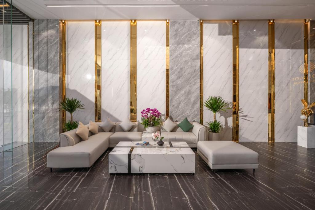 A formal lobby seating arrangement is framed by glossy marble and gold accents.