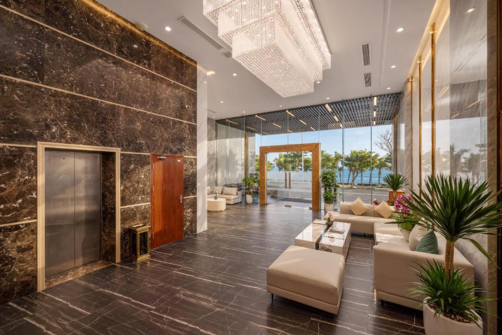 A polished lobby combines lounge seating, plants and large windows facing the coast.