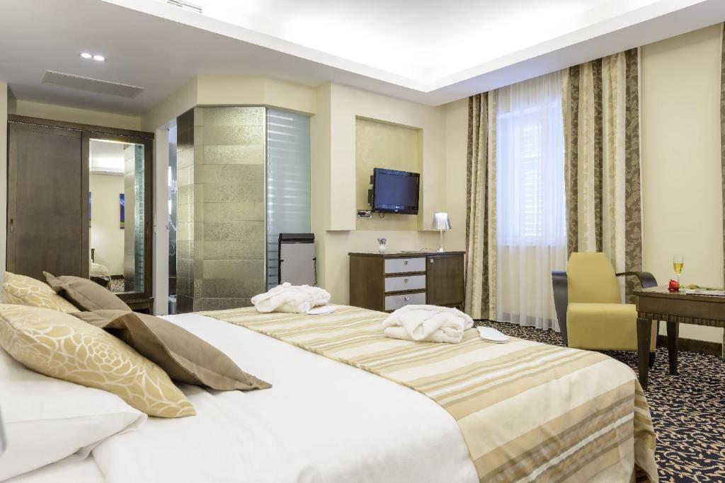 Postel nebo postele na pokoji v ubytování Hotel Lapad