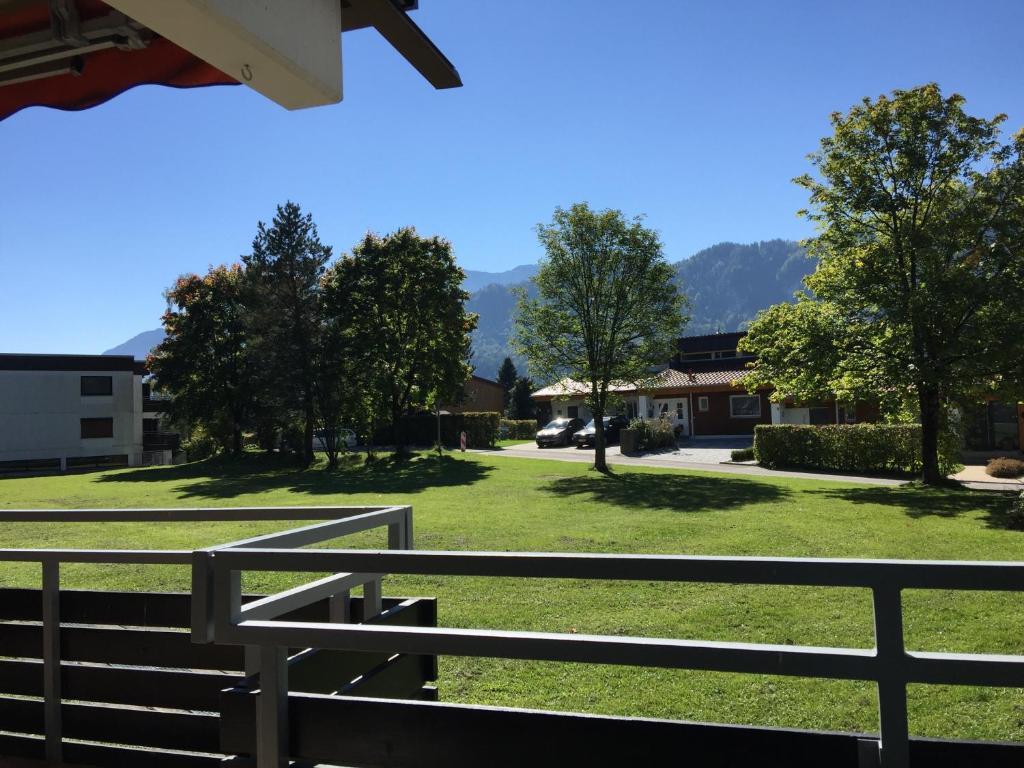 Blick auf einen Park mit einem Zaun und Bäumen in der Unterkunft Ferienwohnung Seefelder in Füssen