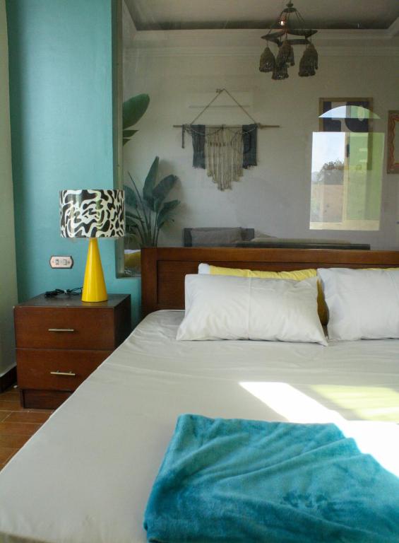 a bedroom with a bed and a lamp on a table at Tecoma studios Lighthouse in Dahab