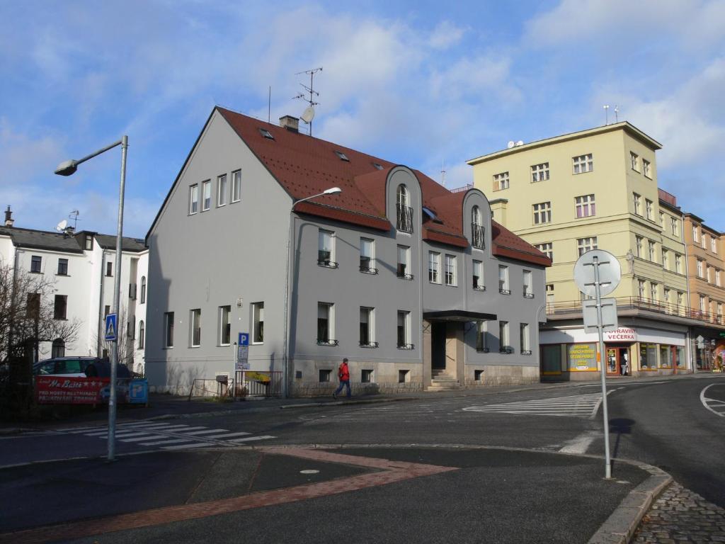 a large white building with a red roof on a street at Hotel Na Baste in Jablonec nad Nisou