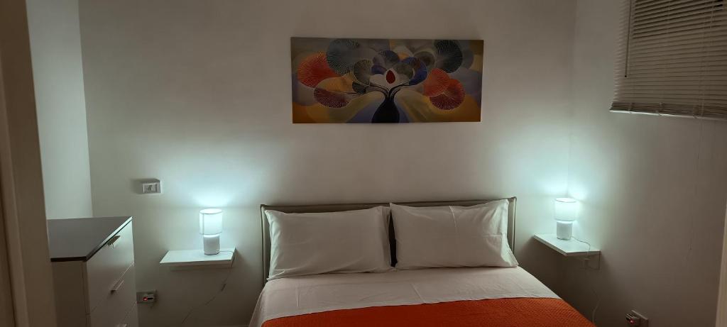 a bedroom with a bed with two lights on at Il Cas8tto in Pozzuoli