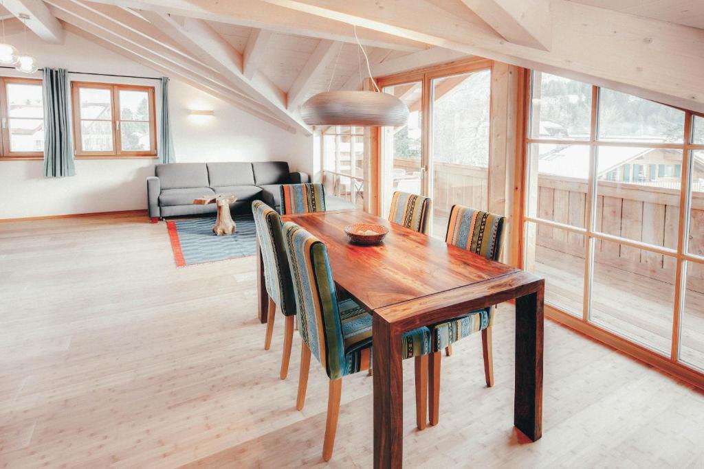 a dining room with a wooden table and chairs at Luna Blanca - Apartment 3 in Schwangau
