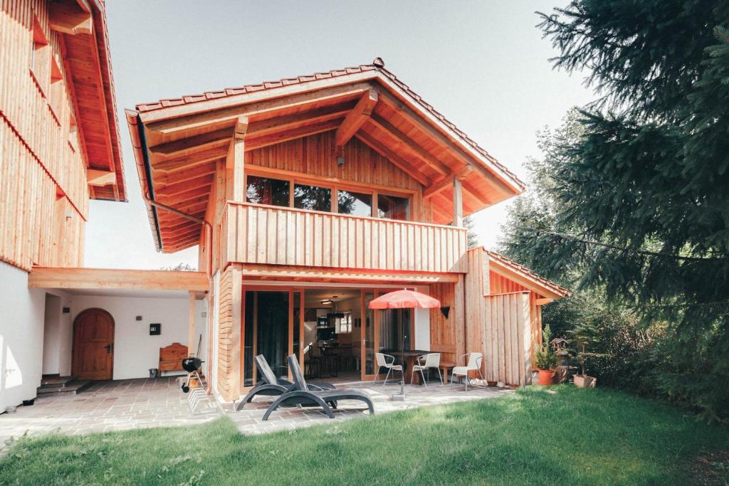 a wooden house with a patio and a table at Luna Blanca Chalet in Schwangau