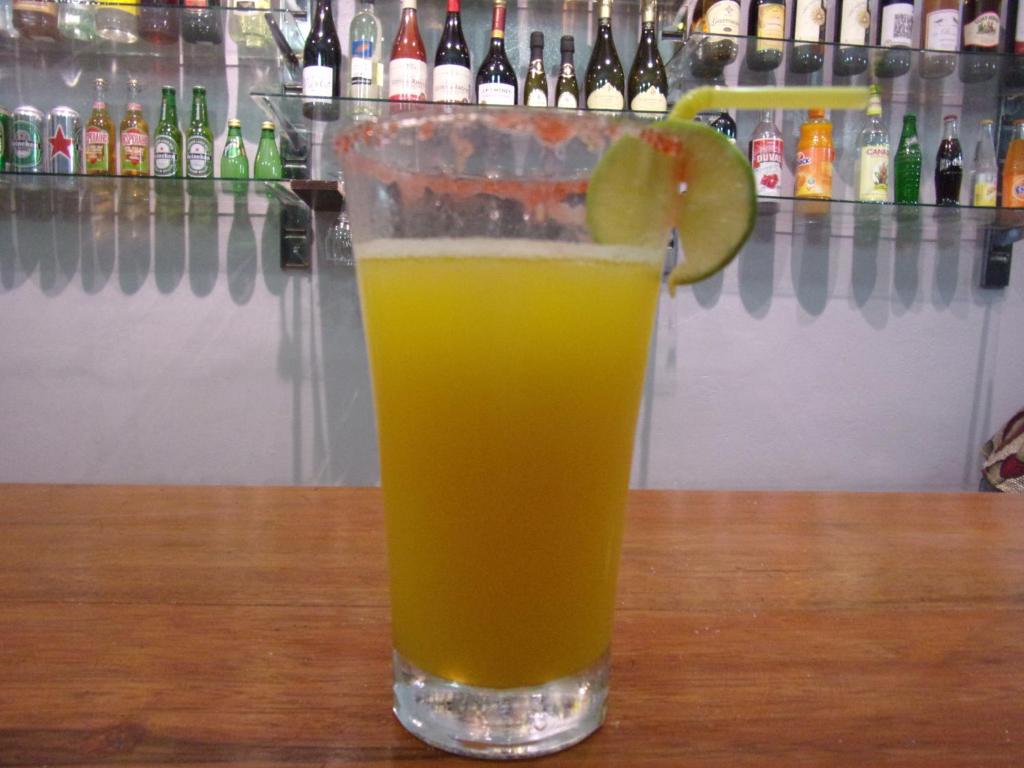 a glass of orange juice sitting on a table at Melia Hotel in Saly Portudal