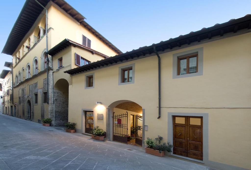 a row of buildings on a cobblestone street at Accademia Residence in Prato