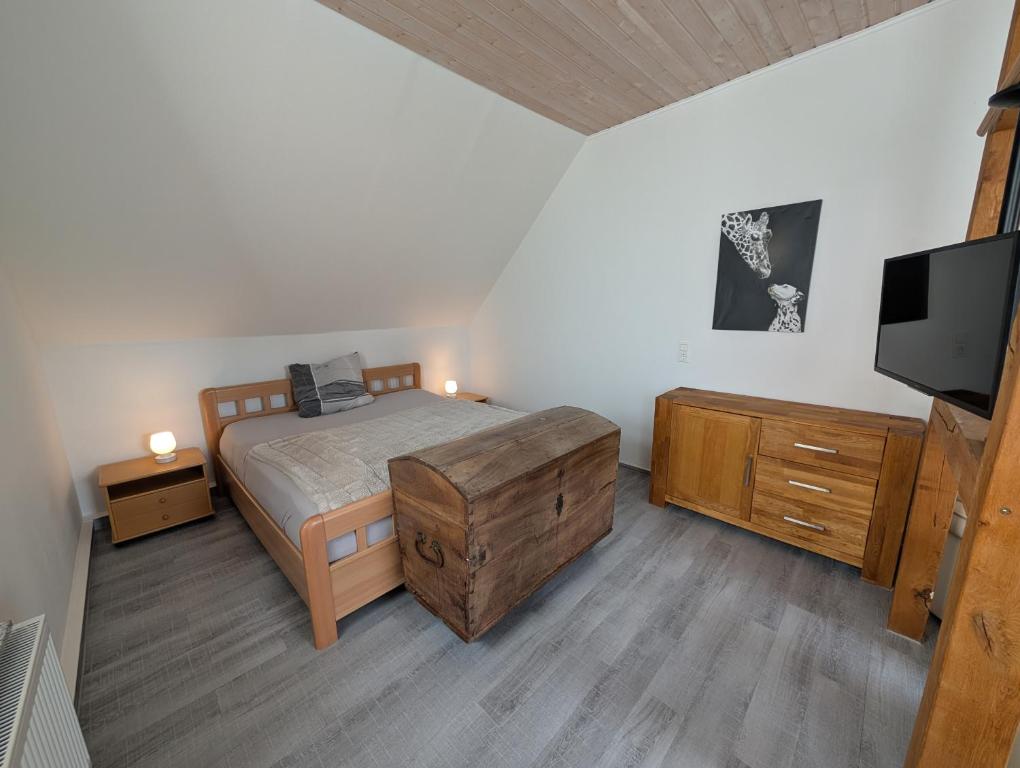 a bedroom with a bed and a flat screen tv at Alte Stadthauswohnung mit Flair in Celle