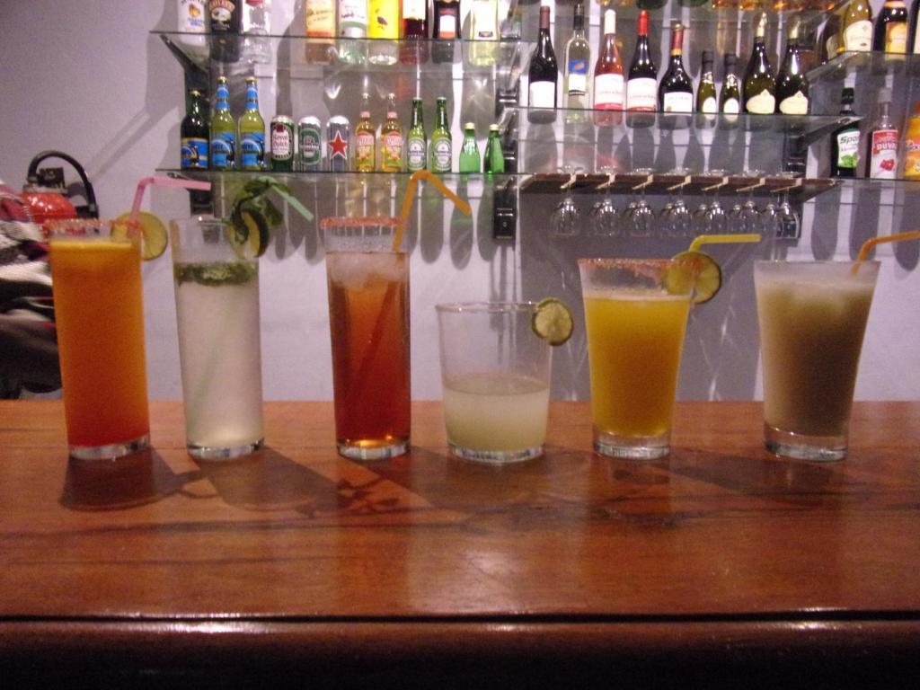 a group of different types of drinks on a bar at Melia Hotel in Saly Portudal