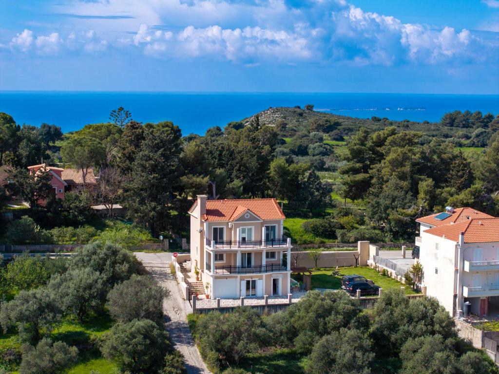 an aerial view of a house with the ocean in the background at Avra Charming House in Khelmáta