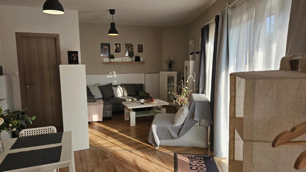 a living room with a couch and a table at Sunlight Apartmanház in Velence