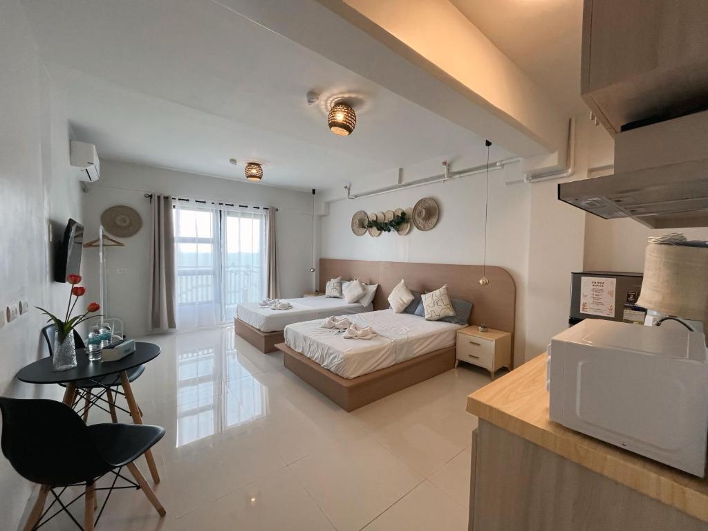 a large room with two beds and a table at Royal Oceancrest Panglao 1020 in Dao