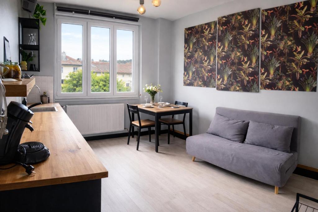 a living room with a couch and a table at La Villa Pauze in Royat