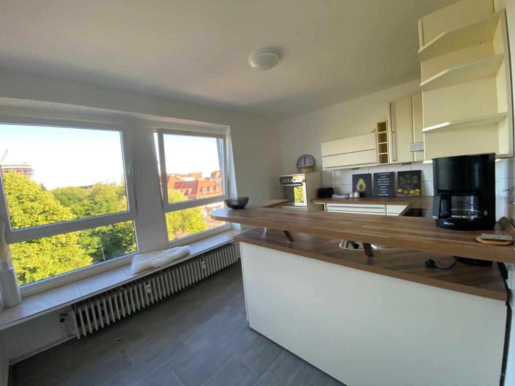 a kitchen with a counter top and two windows at Deck in Cuxhaven