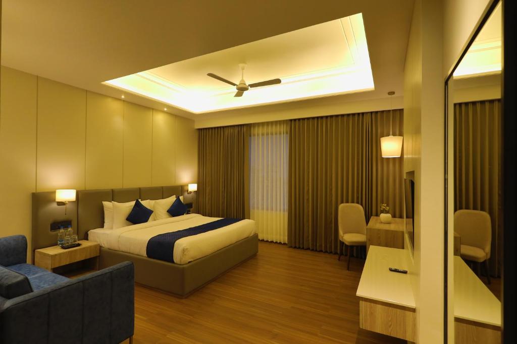 a hotel room with a bed and a couch at BB Grand in Sunām