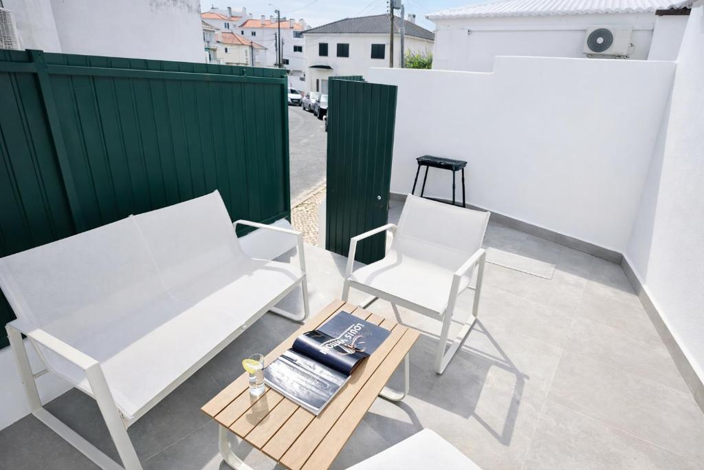 two white chairs and a table on a balcony at Cascais Garden House 101 in Cascais