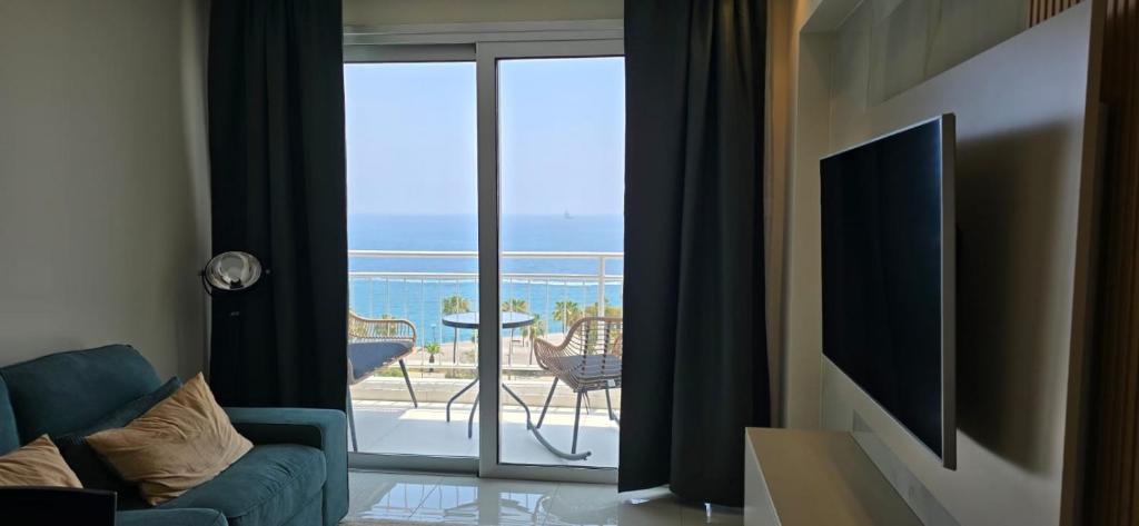a living room with a view of the ocean at SEAFRONT 1BDR, Panoramic views, central Marina in Limassol
