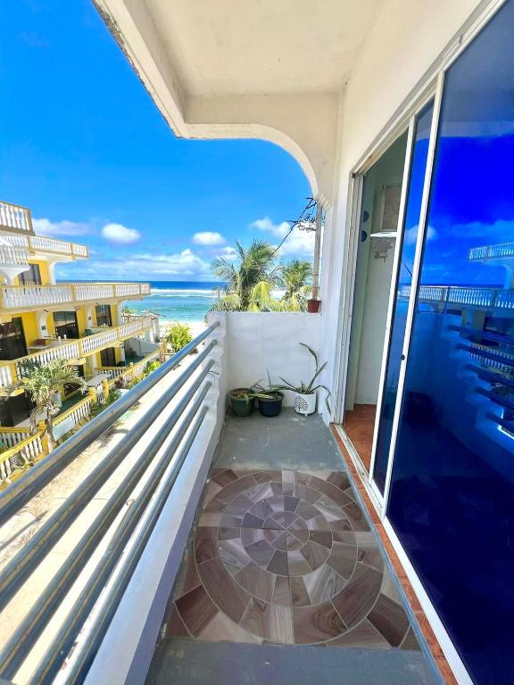 a balcony with a view of the ocean at Bulan Guesthouse in San Isidro