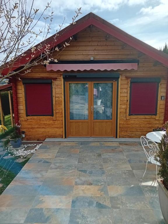 a cottage with a patio in front of it at Chalet d'Art in Saint-Georges