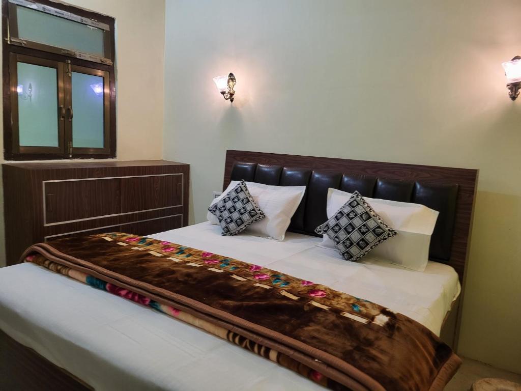 a bedroom with a bed with a blanket on it at Narayan homestay guesthouse in Ayodhya