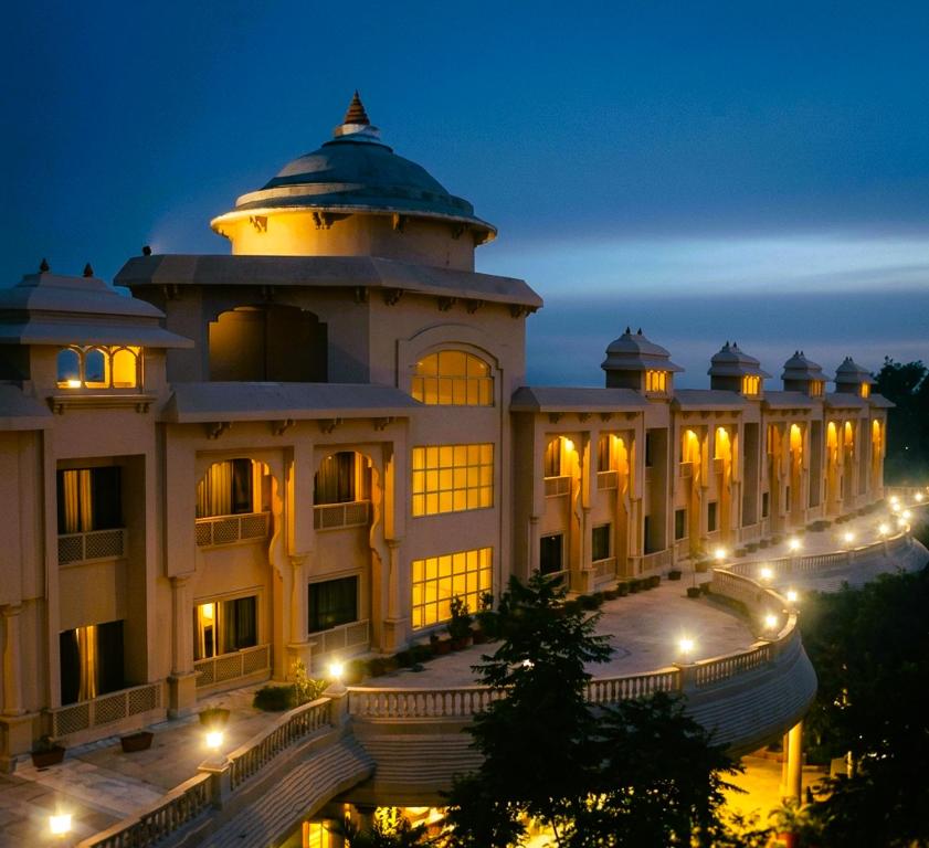 a building with a dome on top at night at Shraddha Inn - Shirdi in Shirdi
