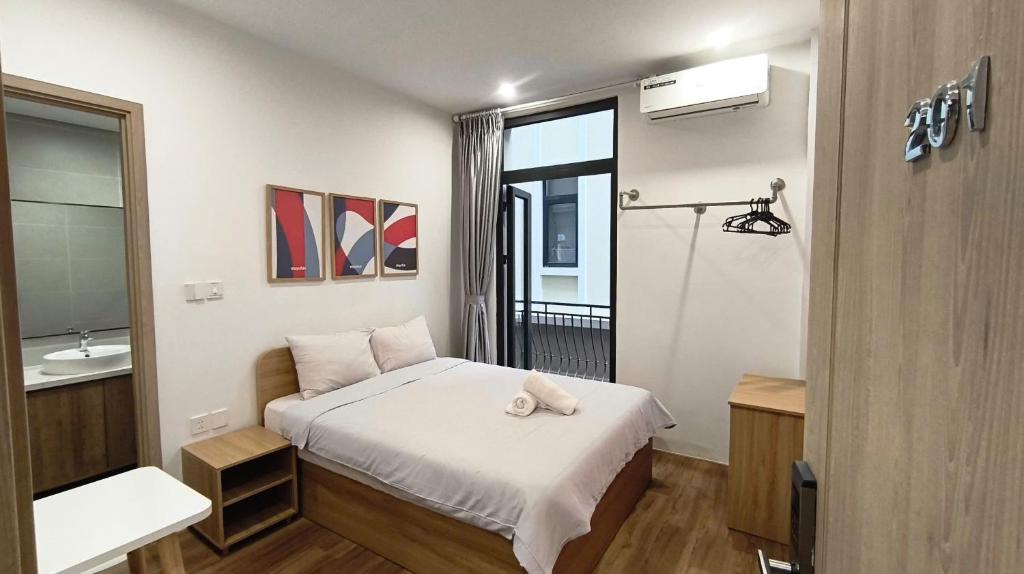 a small bedroom with a bed and a bathroom at LokoOne Central Hub in Hòa Bình
