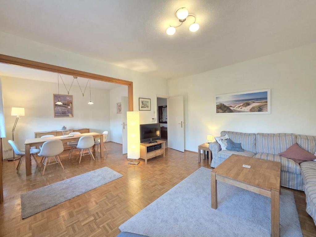 a living room with a couch and a table at Ferienhaus Teddis Haus in Norden