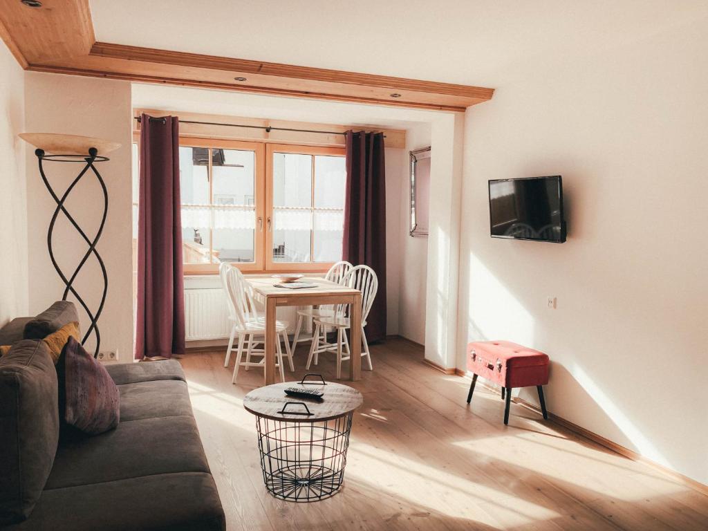 a living room with a couch and a table at Haus Luna - Apartment Luna 6 in Schwangau